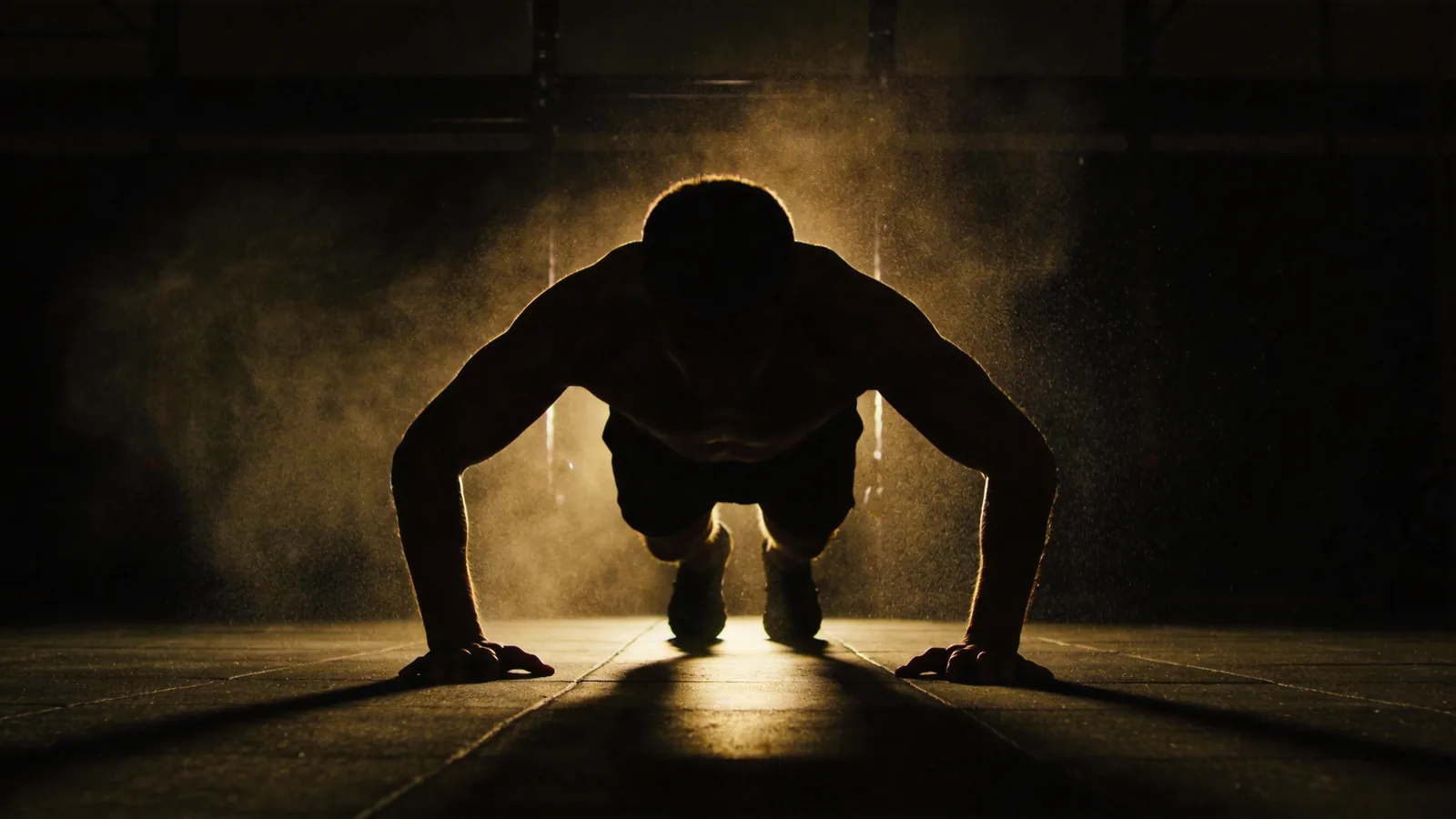 A fighter braced low on the mat in a sprawl